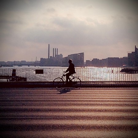 Cyclist riding on bridge over Nyhavn River