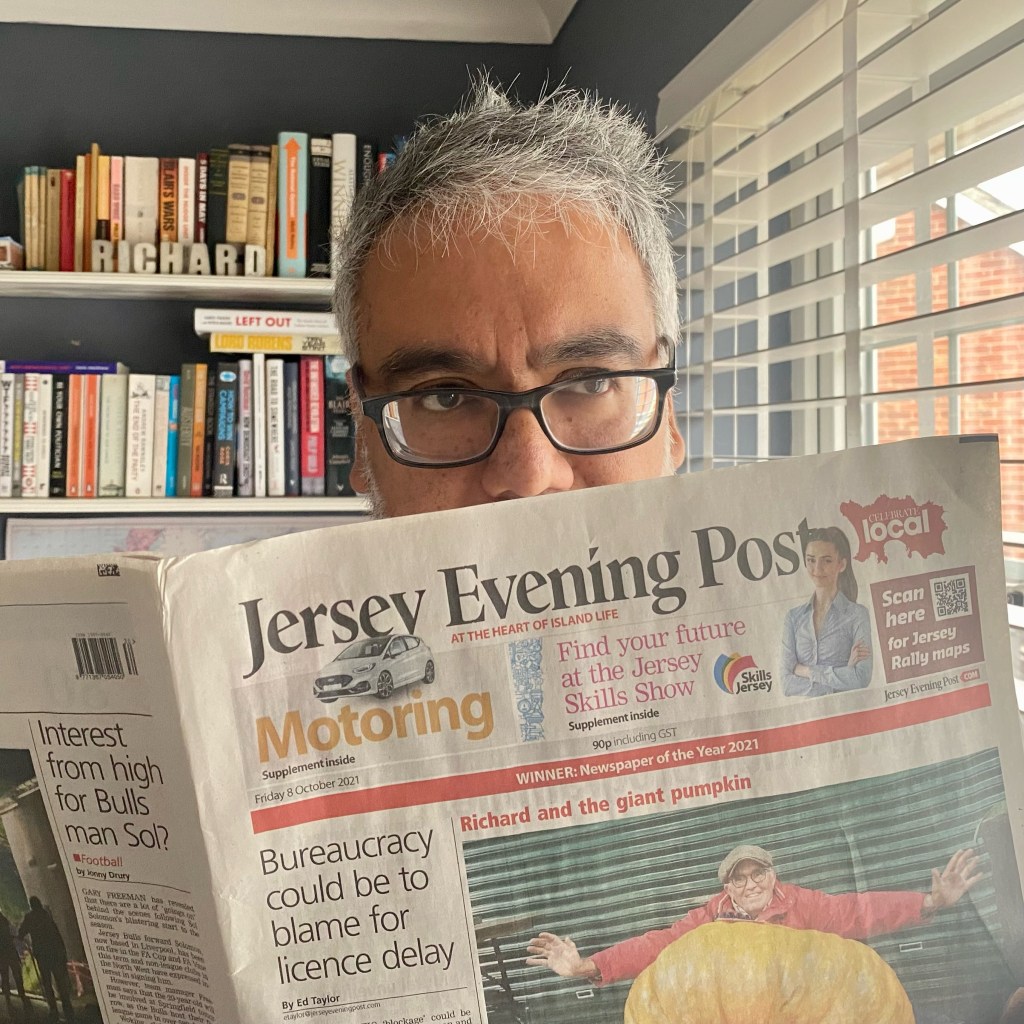 Me reading the Jersey Evening Post 